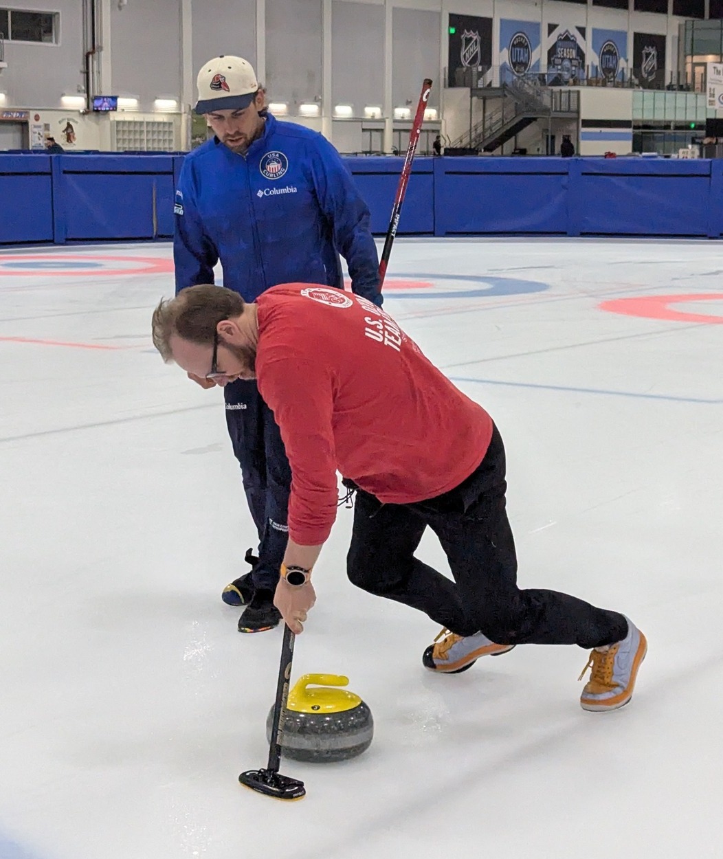 May be an image of 3 people, people playing hockey and people skating